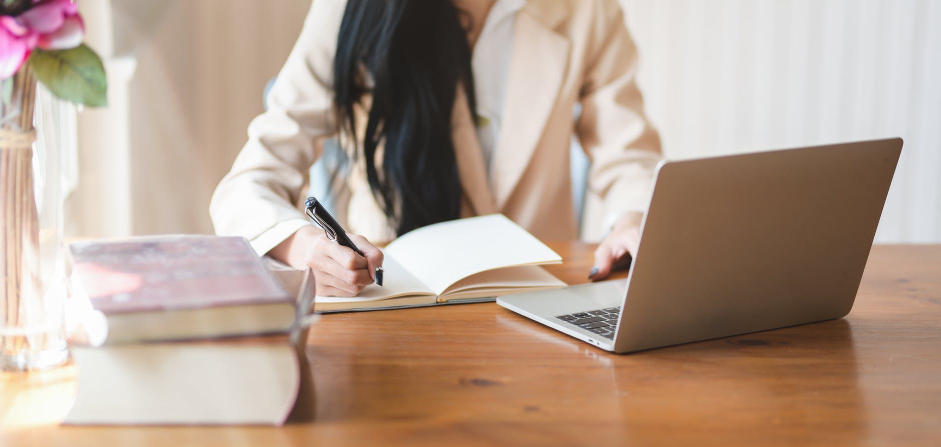 woman writing on notebook