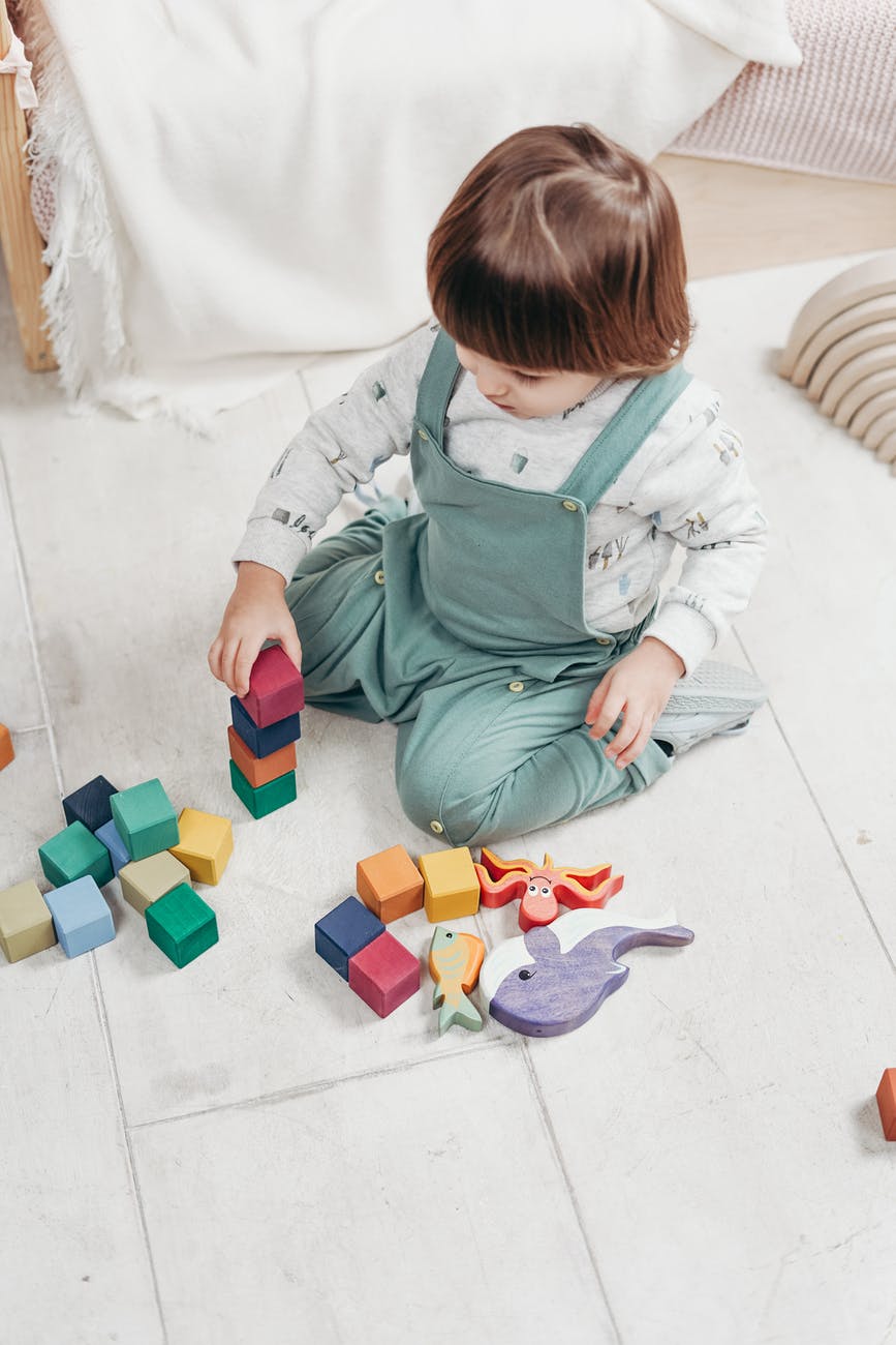 a child sitting on the floor playing with toys